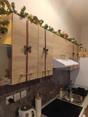 a kitchen with christmas decorations on the cabinets at Studio 35 - Modern & Cozy Studio in Chalandri City Center in Athens
