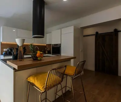 a kitchen with two bar stools and a counter top at Koukaki Vibe in Athens