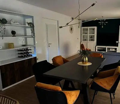 a dining room with a black table and chairs at Koukaki Vibe in Athens