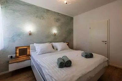 a bedroom with a bed with two towels on it at Koukaki Vibe in Athens