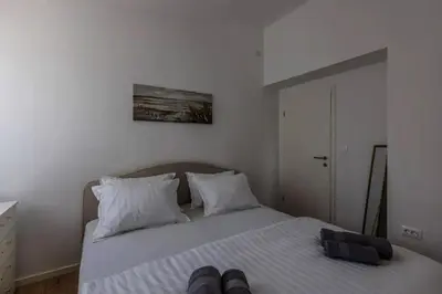 a bedroom with a white bed with two pillows at Koukaki Vibe in Athens