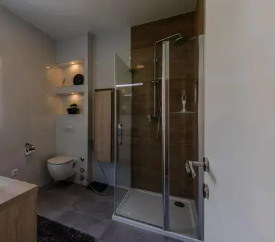 a bathroom with a glass shower with a toilet at Koukaki Vibe in Athens