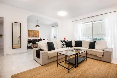 a living room with a couch and a table at Elysian Smyrni - Marble Elegance Retreat in Athens