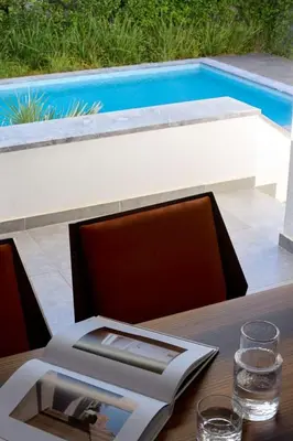 a table with a book and a laptop on top of it at Villa Riviera in Vari