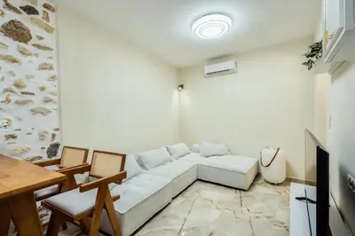 a living room with a couch and a table at The Marble Retreat in Athens
