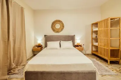 a bedroom with a bed and a mirror on the wall at The Marble Retreat in Athens