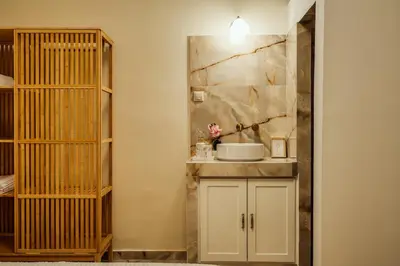 a small bathroom with a sink and a shelf at The Marble Retreat in Athens