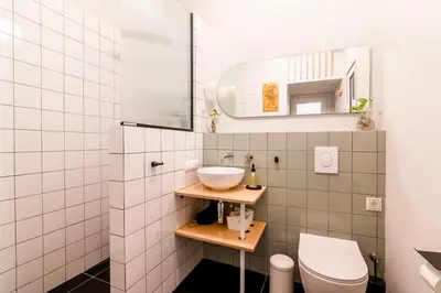 a bathroom with a sink and a toilet at Fluffy clouds Psiri Athens in Athens
