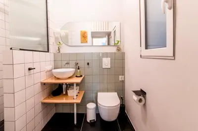 a small bathroom with a sink and a toilet at Fluffy clouds Psiri Athens in Athens