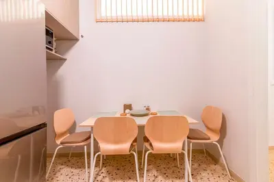 a dining room with a table and four chairs at Fluffy clouds Psiri Athens in Athens