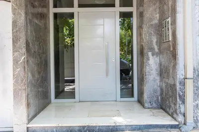 a white door on the side of a building at Fluffy clouds Psiri Athens in Athens
