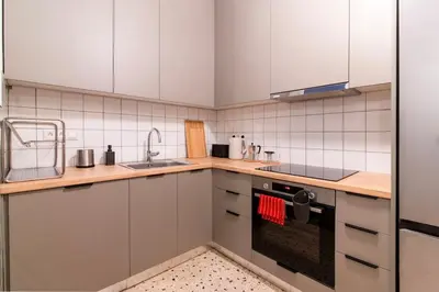 a kitchen with white cabinets and a sink at Fluffy clouds Psiri Athens in Athens