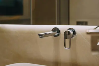 a close up of a bathroom sink with a faucet at Chic and Cozy Apartment in the Heart of Glyfada in Athens