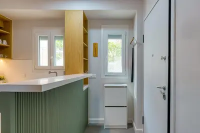 a small kitchen with a sink and a shower at Chic and Cozy Apartment in the Heart of Glyfada in Athens