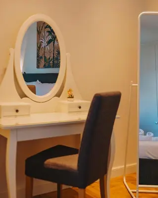 a bedroom with a desk with a mirror and a chair at Chic and Cozy Apartment in the Heart of Glyfada in Athens