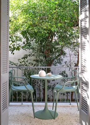 a table and two chairs sitting on a porch at 12ve Plaka, a Chic Apartment in the Heart of Plaka in Athens