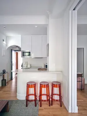 a kitchen with two bar stools and a counter at 12ve Plaka, a Chic Apartment in the Heart of Plaka in Athens