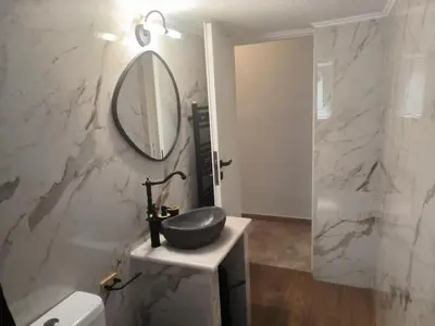 a bathroom with a sink and a mirror at Casa Dili Stylish 2BR Apartment in Athens