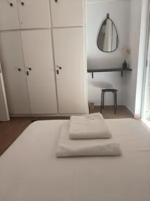 a bedroom with a bed with two towels on it at Casa Dili Stylish 2BR Apartment in Athens