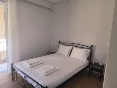 a bedroom with a bed with two towels on it at Casa Dili Stylish 2BR Apartment in Athens