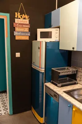 a kitchen with a blue refrigerator and a microwave at Pop Art Escape - Zografou by ΜΡS in Athens