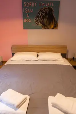 a bed with two towels sitting on top of it at Pop Art Escape - Zografou by ΜΡS in Athens