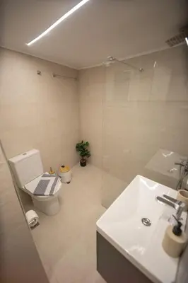 a bathroom with a toilet and a sink and a shower at Pop Art Escape - Zografou by ΜΡS in Athens