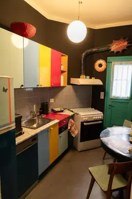a kitchen with colorful cabinets and a table in it at Pop Art Escape - Zografou by ΜΡS in Athens