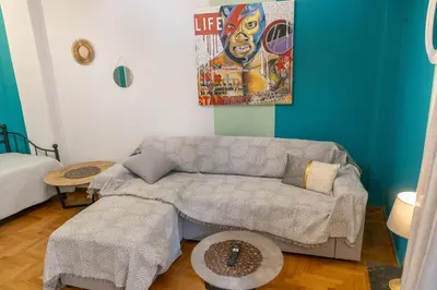 a living room with a couch and a table at Pop Art Escape - Zografou by ΜΡS in Athens
