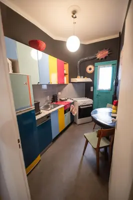 a kitchen with colorful cabinets and a table in it at Pop Art Escape - Zografou by ΜΡS in Athens