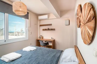 a bedroom with a bed and a window and a desk at Highly aesthetic apartment in Glyfada in Athens