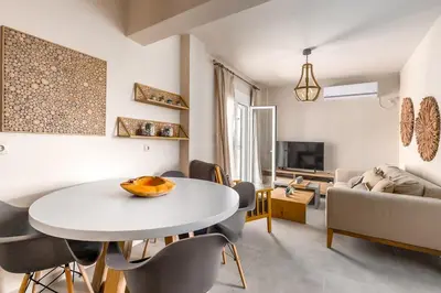 a living room with a white table and chairs at Highly aesthetic apartment in Glyfada in Athens