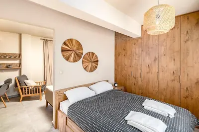 a bedroom with a bed with a wooden wall at Highly aesthetic apartment in Glyfada in Athens