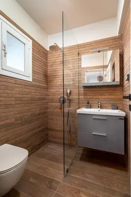 a bathroom with a shower and a toilet and a sink at Highly aesthetic apartment in Glyfada in Athens