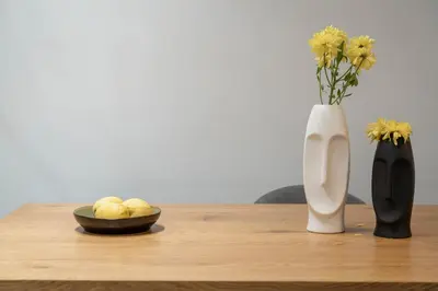 a wooden table with a vase and a bowl of fruit and a vase at Acropolis Oasis - 2BR, Koukaki in Athens