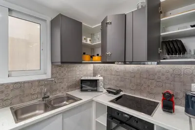 a kitchen with a sink and a microwave at Acropolis Oasis - 2BR, Koukaki in Athens
