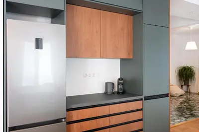a kitchen with wood and stainless steel appliances at Navarino Athenian Nest in Athens