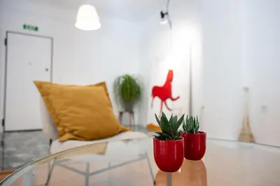 two red vases on a glass table in a living room at Navarino Athenian Nest in Athens
