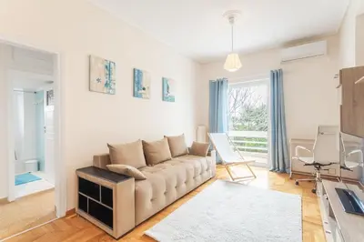 a living room with a couch and a table at Beachside Apartment - Available per month in Athens