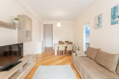 a living room with a couch and a table at Beachside Apartment - Available per month in Athens