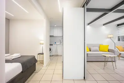 a bedroom with a bed and a living room at Urban Patio Apartment in Athens