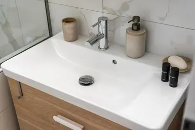 a white sink in a bathroom with a mirror at Urban Patio Apartment in Athens