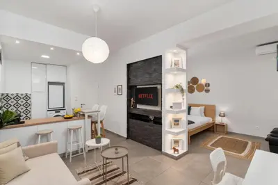 a living room with a couch and a table in a room at Urban Nest - Studio, Neos Kosmos in Athens