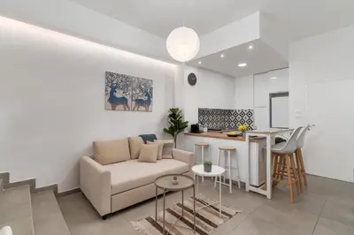 a living room and kitchen with a couch and a table at Urban Nest - Studio, Neos Kosmos in Athens