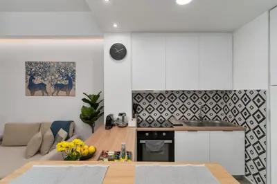 a kitchen and a living room with a table at Urban Nest - Studio, Neos Kosmos in Athens