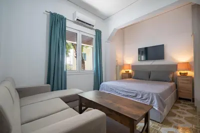 a bedroom with a bed and a couch and a tv at Petrαlonα 1-Bdr cοmfort, neαr Metro by Traser in Athens