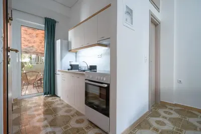 a kitchen with white cabinets and a stove top oven at Petrαlonα 1-Bdr cοmfort, neαr Metro by Traser in Athens
