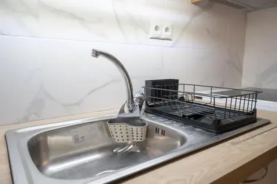 a kitchen sink with a dish drying rack on it at Petrαlonα 1-Bdr cοmfort, neαr Metro by Traser in Athens