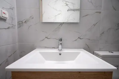 a bathroom with a white sink and a toilet at Petrαlonα 1-Bdr cοmfort, neαr Metro by Traser in Athens