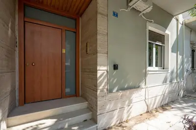 a wooden door on the side of a house at Petrαlonα 1-Bdr cοmfort, neαr Metro by Traser in Athens